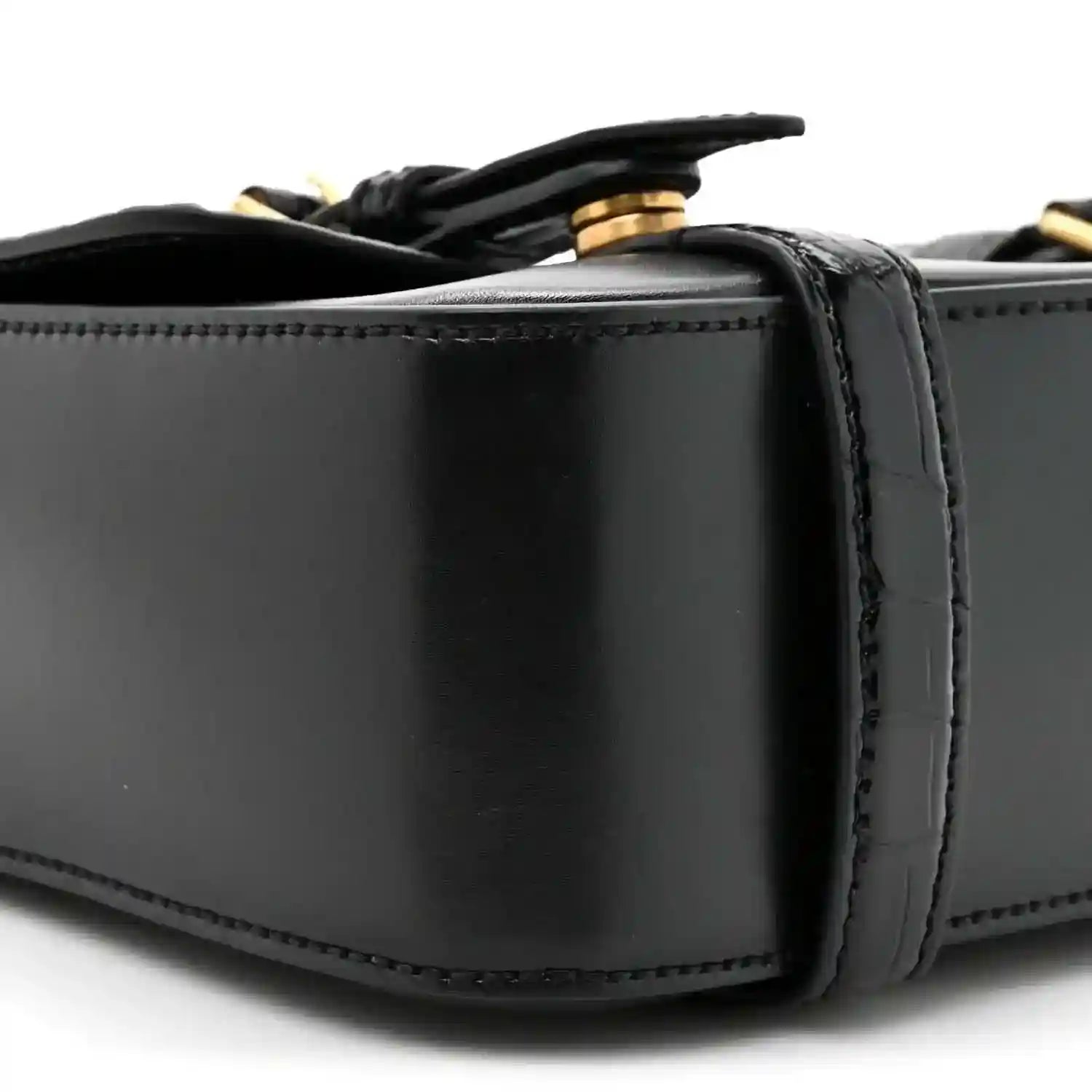 Black leather messenger bag close-up of top edge and strap attachment hardware