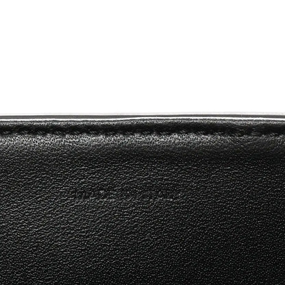 Black grained leather close-up with smooth edge seam detail