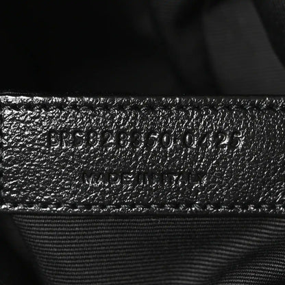 Embossed product code on black leather interior with stitched seam