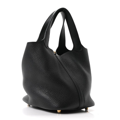 Black pebbled leather tote bag in three-quarter view with slouchy shape and handles
