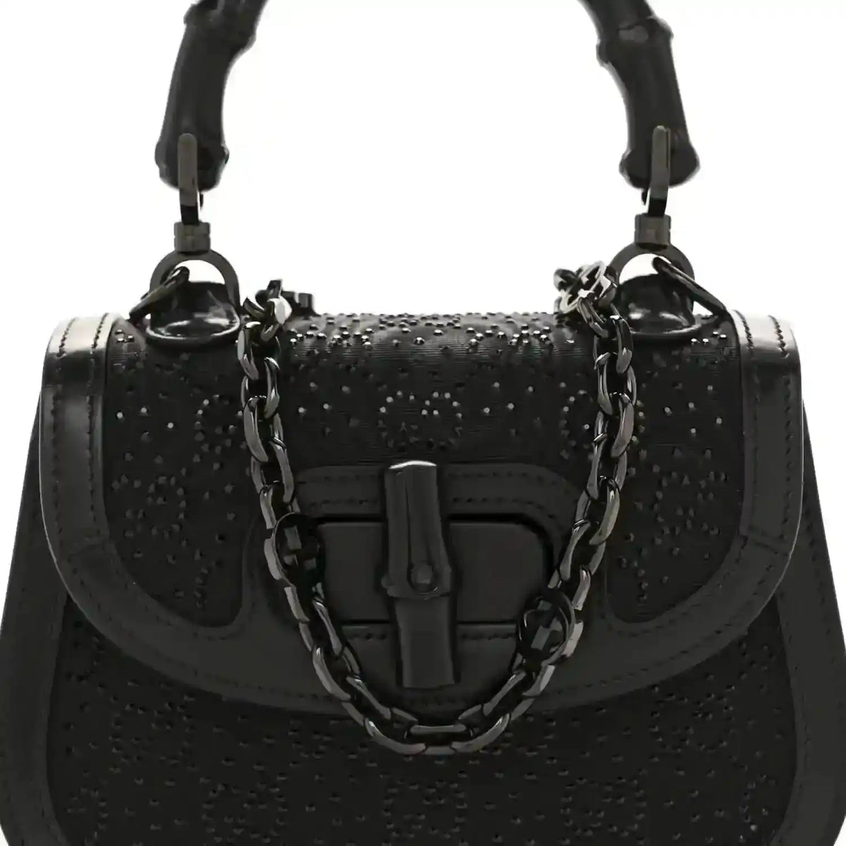 Black mini handbag with bamboo-style handle, chain strap, and front clasp detail.