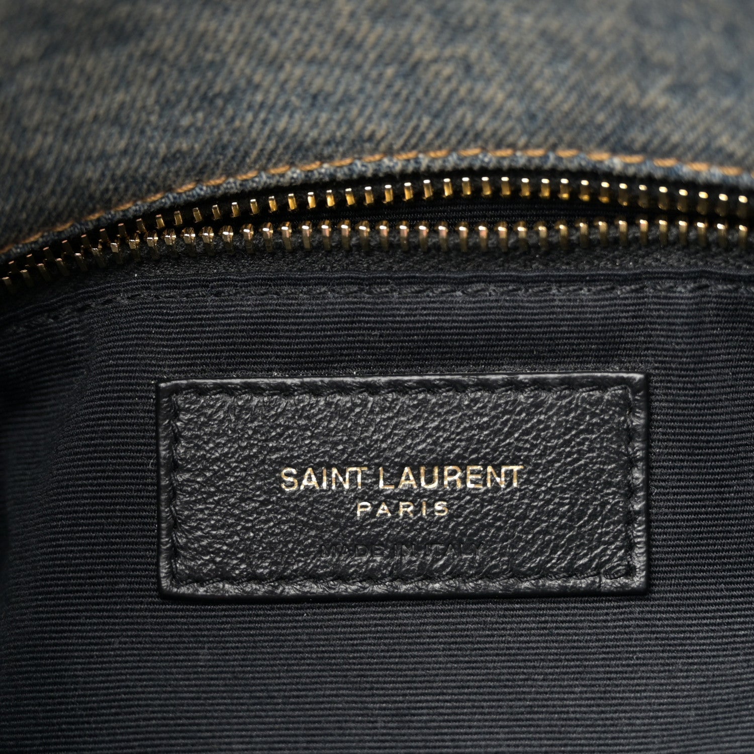 Denim satchel inner label with gold zipper and SAINT LAURENT PARIS branding