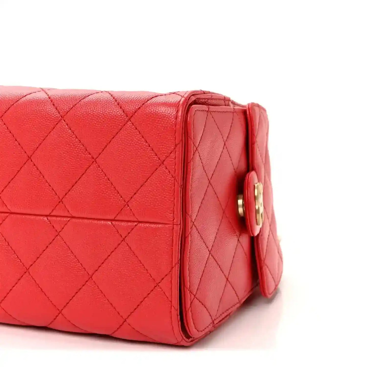 Burgundy quilted leather handbag side seam with gold turn-lock hardware.