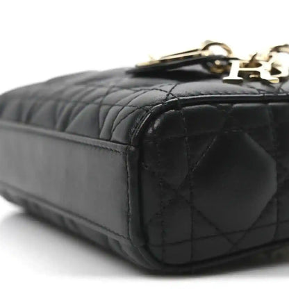 Black quilted mini handbag end with rounded corner and gold-tone clasp