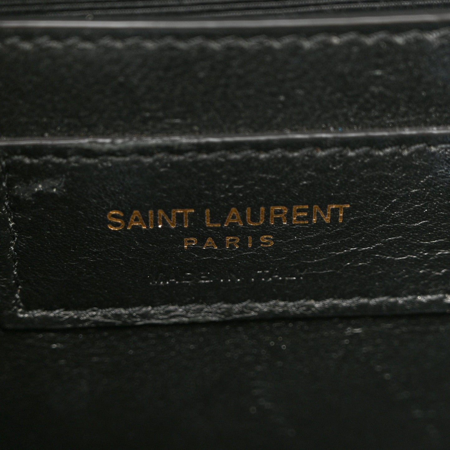 Grain-textured satchel lining with SAINT LAURENT PARIS stamp