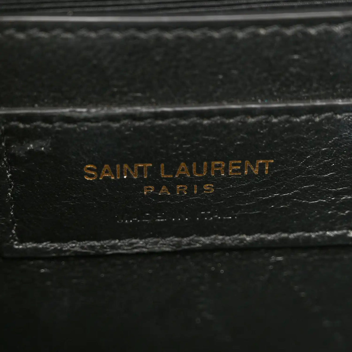 Grain-textured satchel lining with SAINT LAURENT PARIS stamp