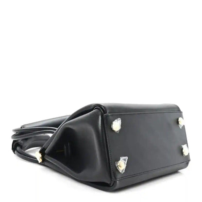 Small black leather handbag with side studs and top handles