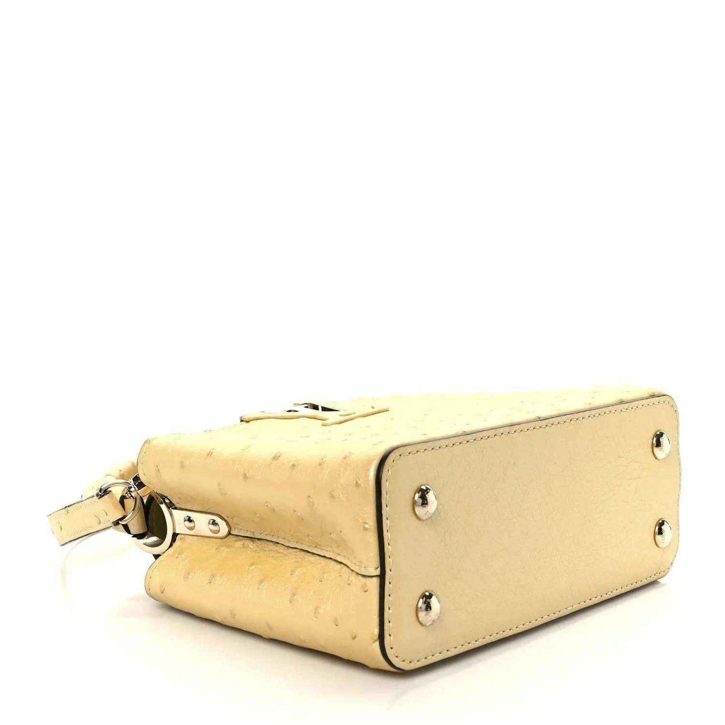 Yellow mini bag with front flap and silver-toned hardware, side view