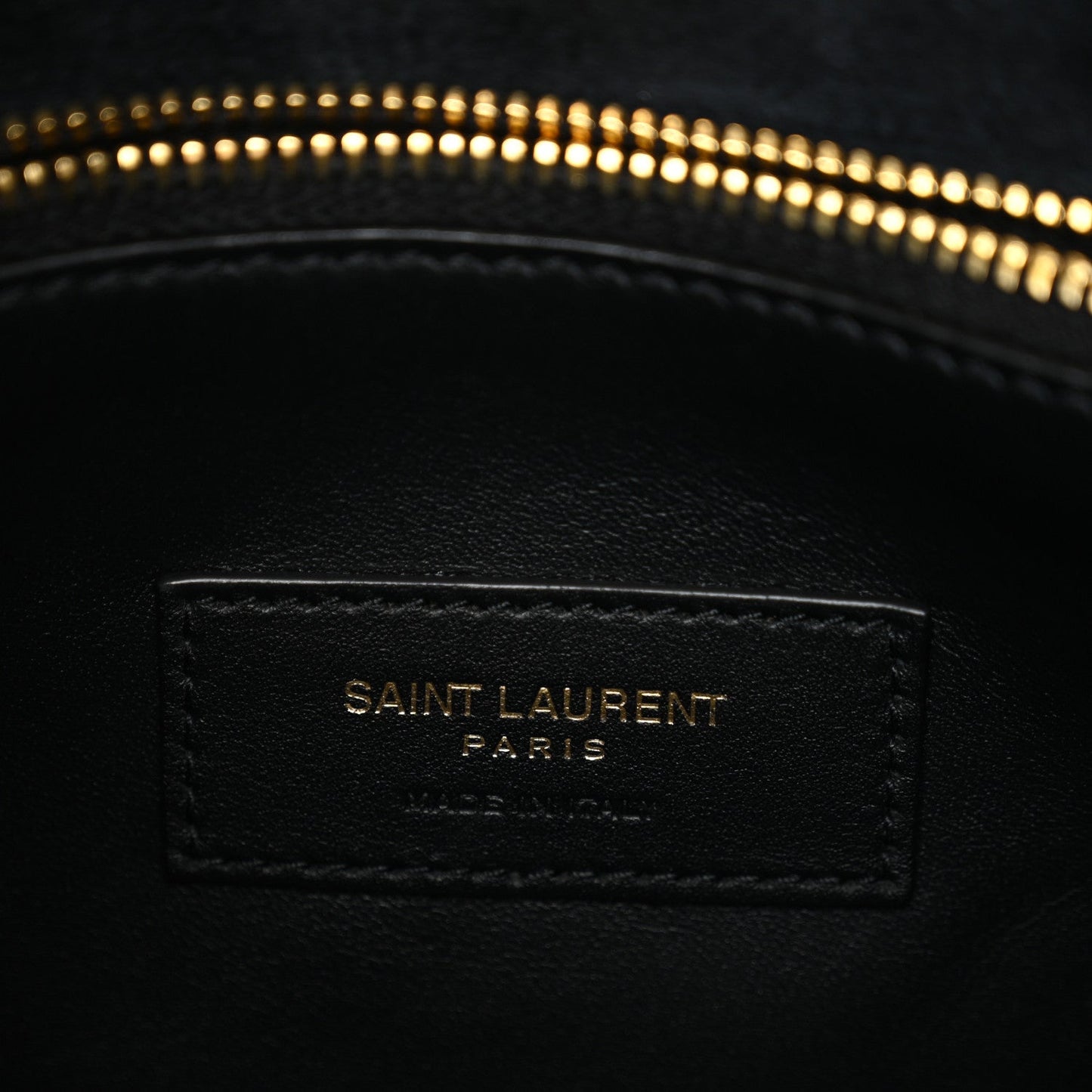 Black leather interior patch label with "SAINT LAURENT PARIS" text.