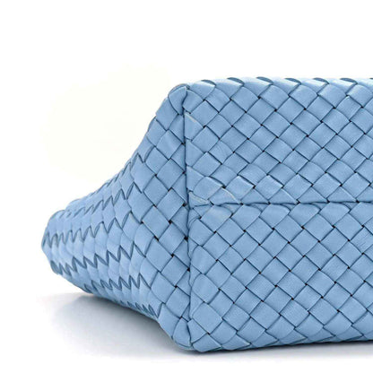 Blue woven mini cabat tote with side panel and strap end, rounded base