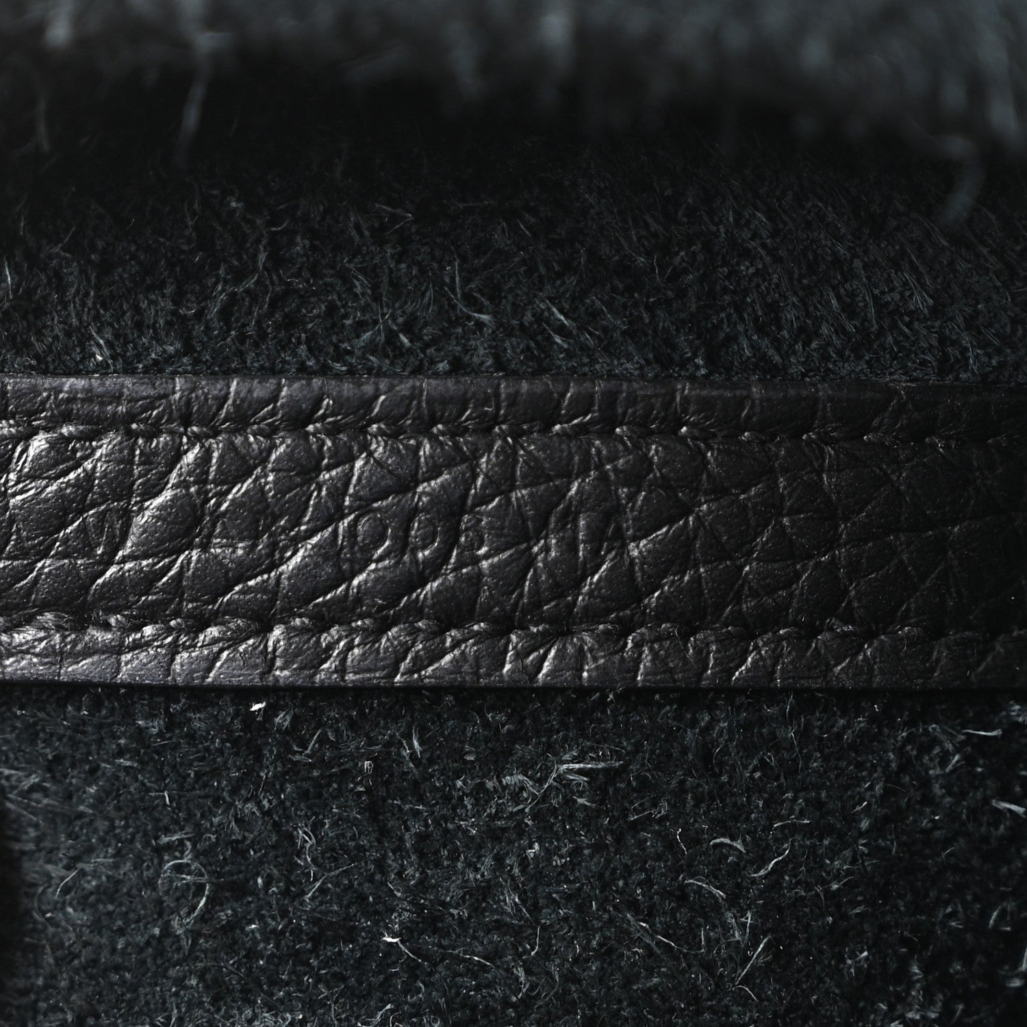 Black leather tote bag stitched seam detail on textured leather panel