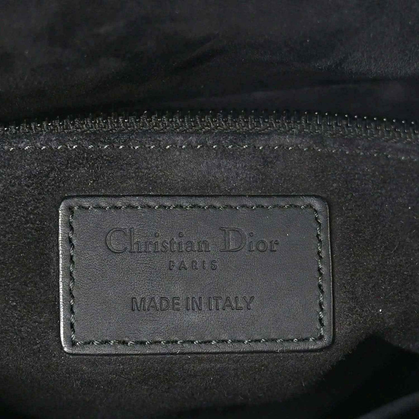 Christian Dior Paris label on black leather bag lining, "Made in Italy"