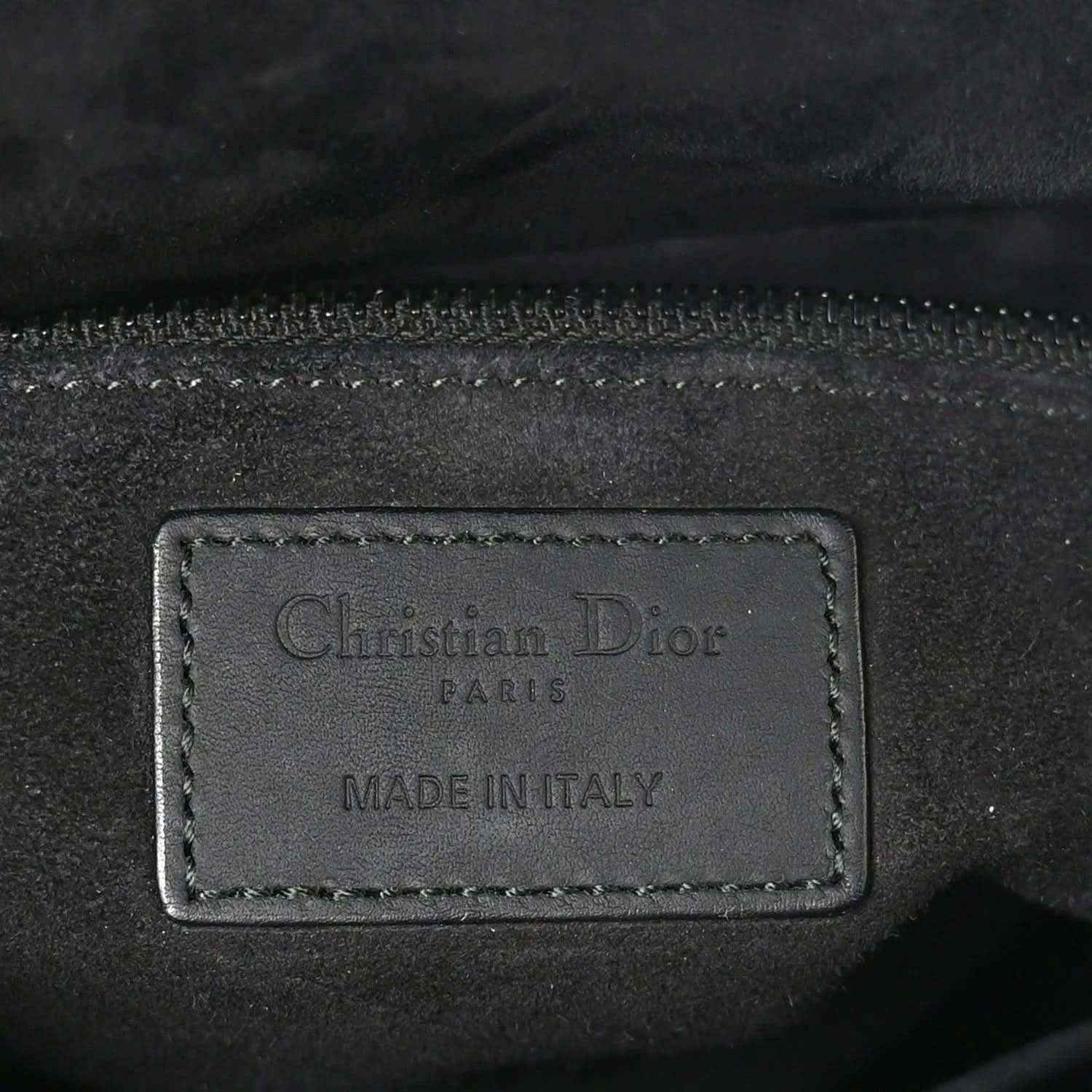 Christian Dior Paris label on black leather bag lining, "Made in Italy"
