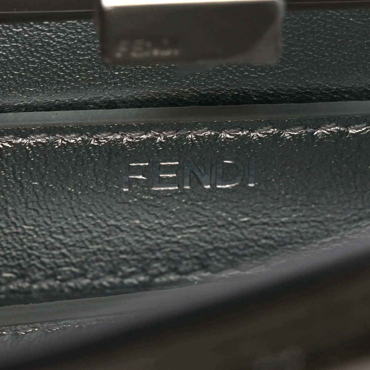 Dark leather interior lining with stamped branding