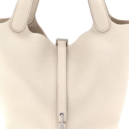 Off-white leather bucket bag top with two handles and central zipper pull