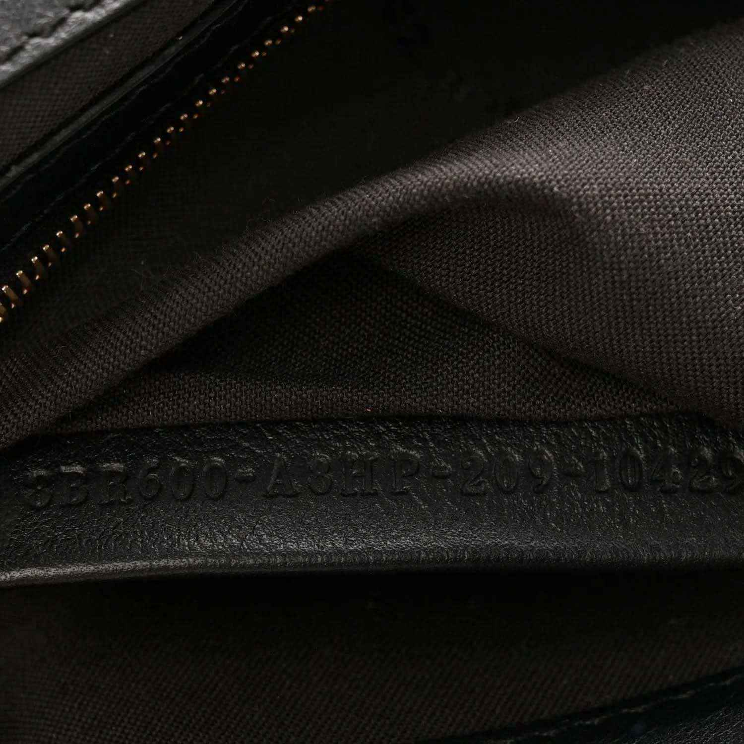 Dark interior fabric lining with stitched seam and zipper trim on the bag.