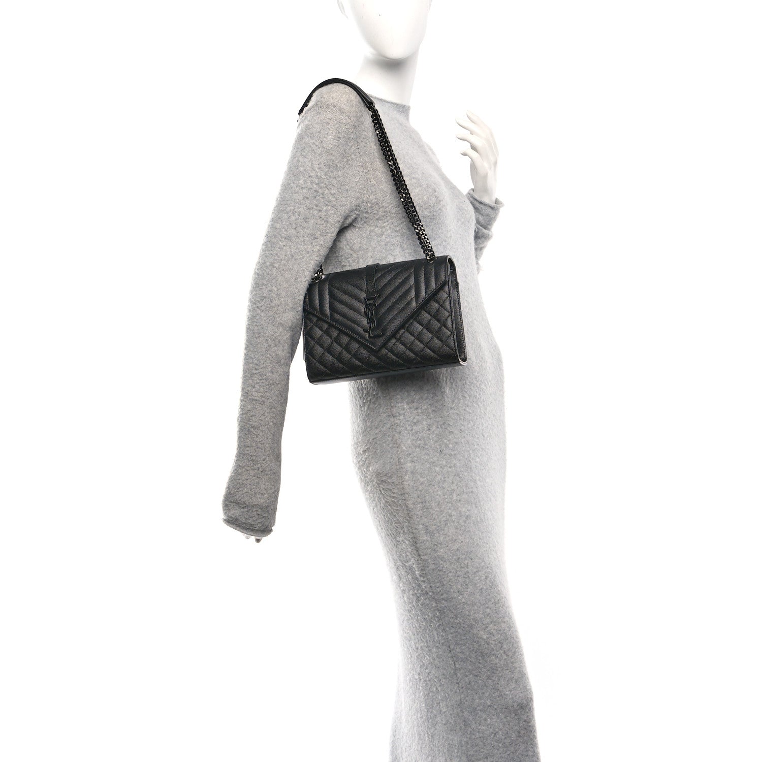 Saint Laurent black matelasse satchel on chain strap, worn at side on a model