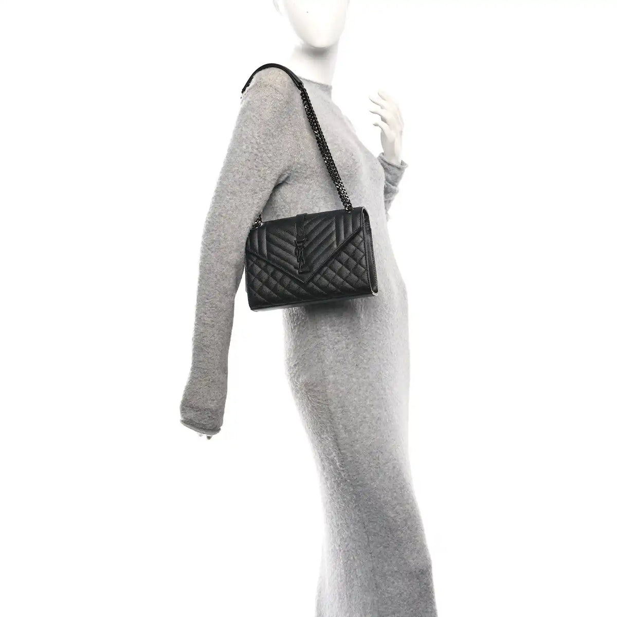 Saint Laurent black matelasse satchel on chain strap, worn at side on a model