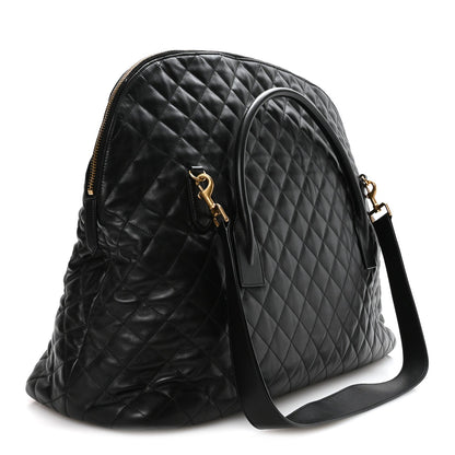 Black quilted leather travel bag with front zip pocket and adjustable shoulder strap