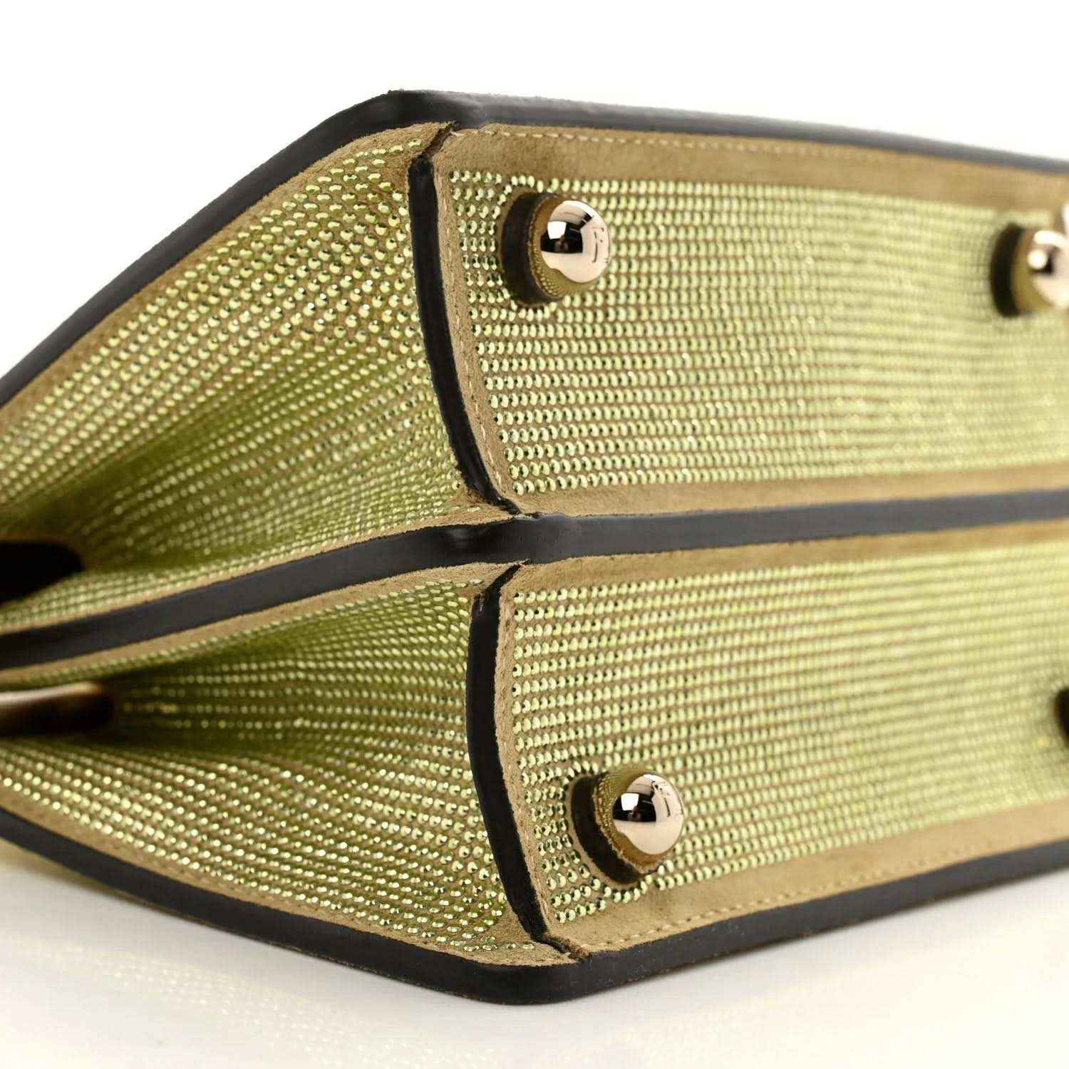 Gold crystal satchel interior with black trim and two jeweled snap panels