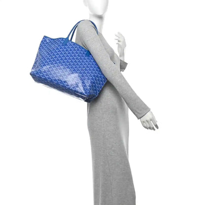 Sky blue tote bag with allover Goyardine pattern and short top handles, side view