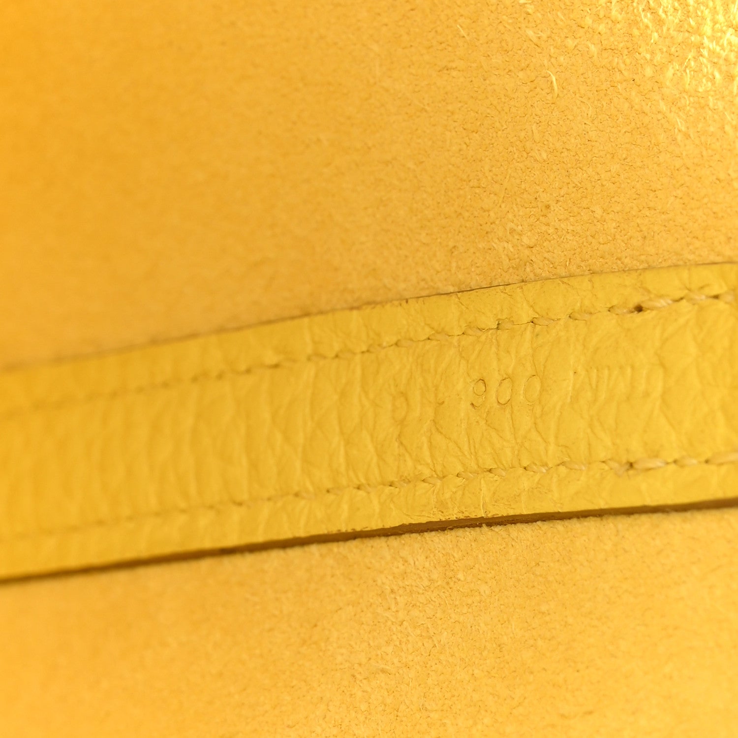 Lime leather seam with stamped marking along the edge
