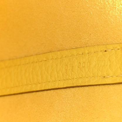 Lime leather seam with stamped marking along the edge