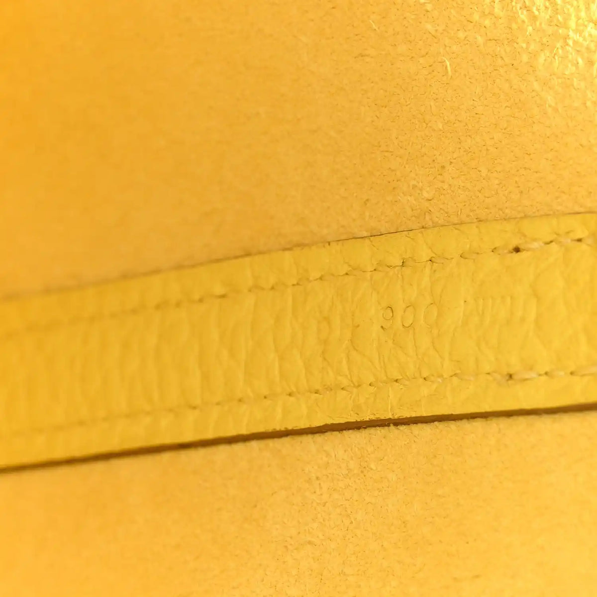 Lime leather seam with stamped marking along the edge