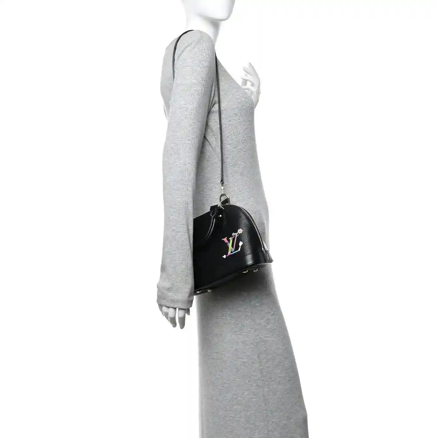 Black handbag on arm with top handle, gold zipper hardware, and colorful LV motif