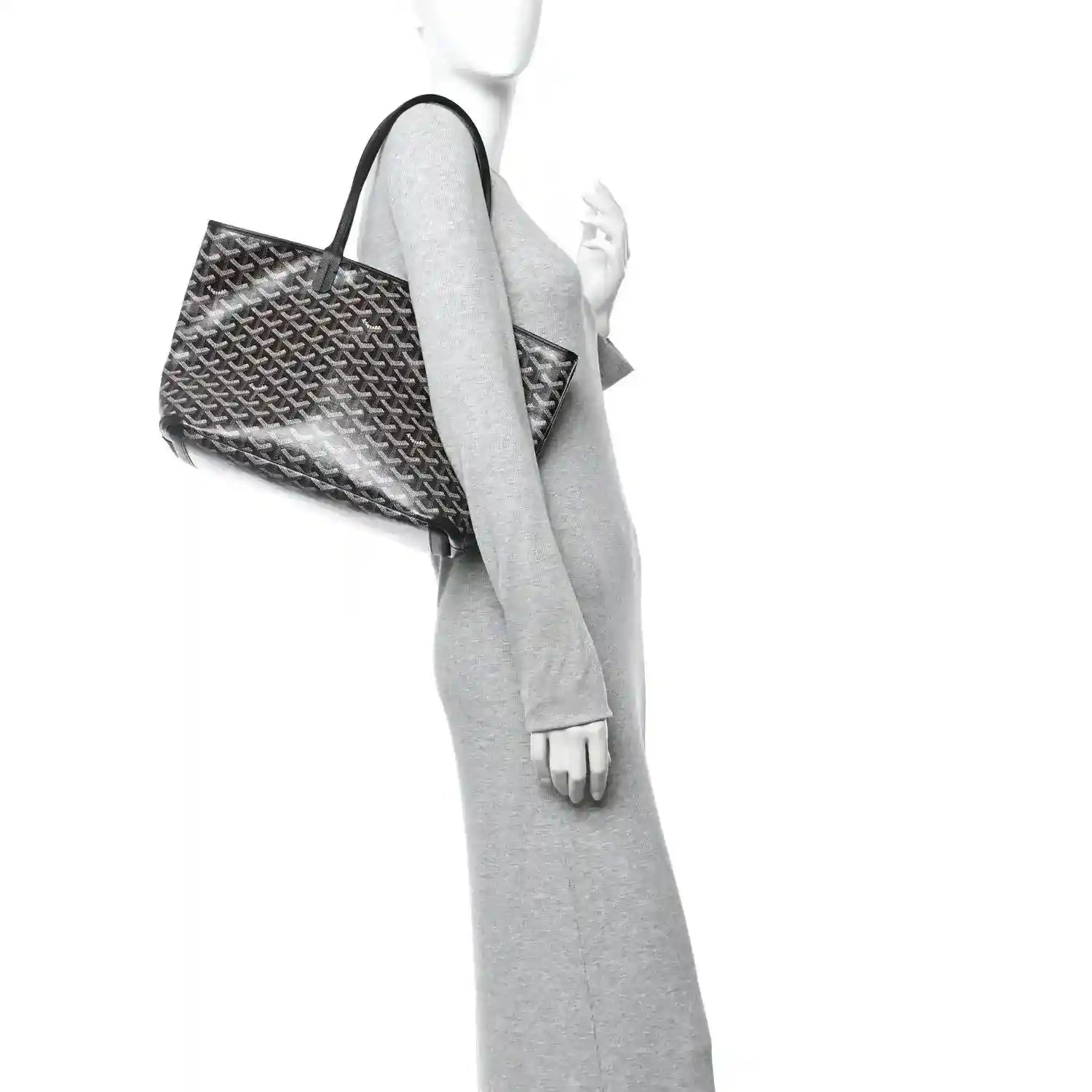 Goyardine PM tote bag with black handles, shown from side with open top.