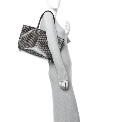Goyardine PM tote bag with black handles, shown from side with open top.