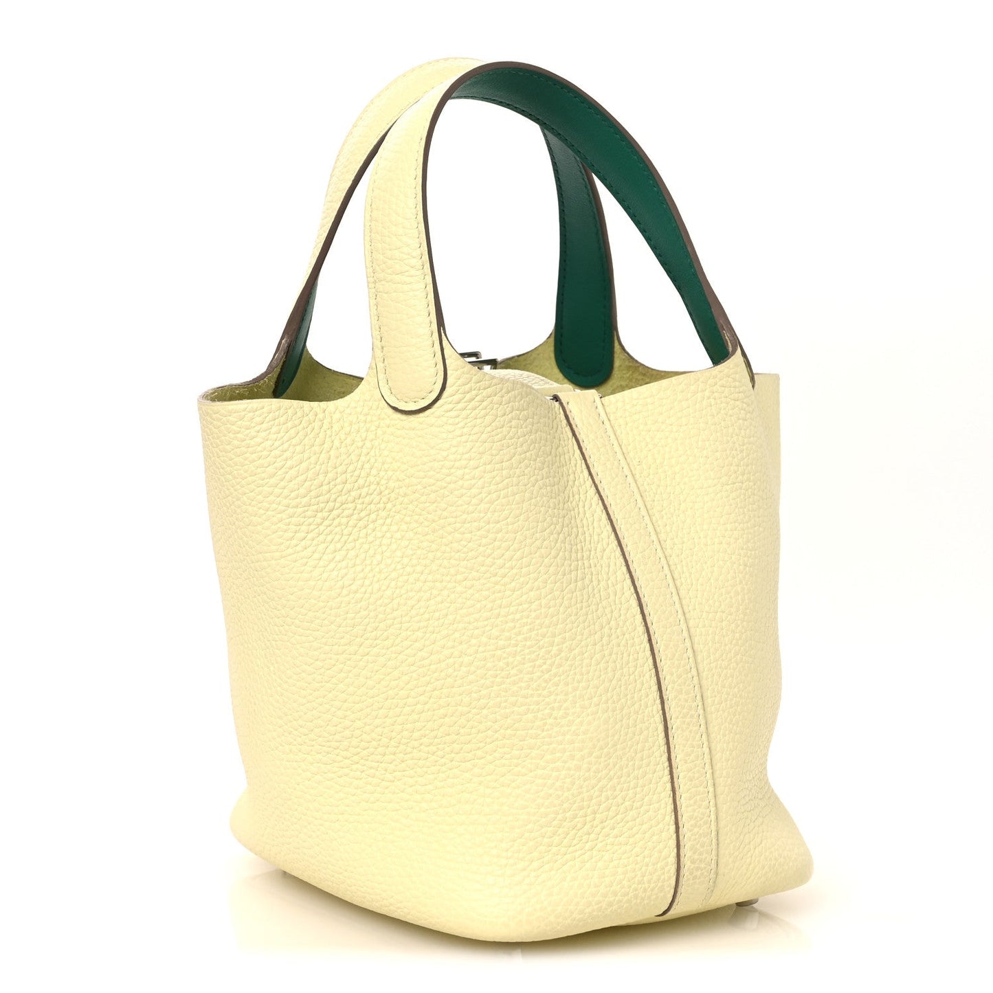 Two-tone leather handbag with yellow exterior and green handle accent, front corner seam.
