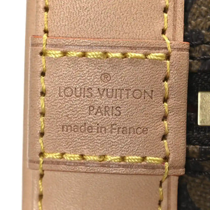 Leather handbag label reading 'Louis Vuitton Paris made in France' with yellow stitching.