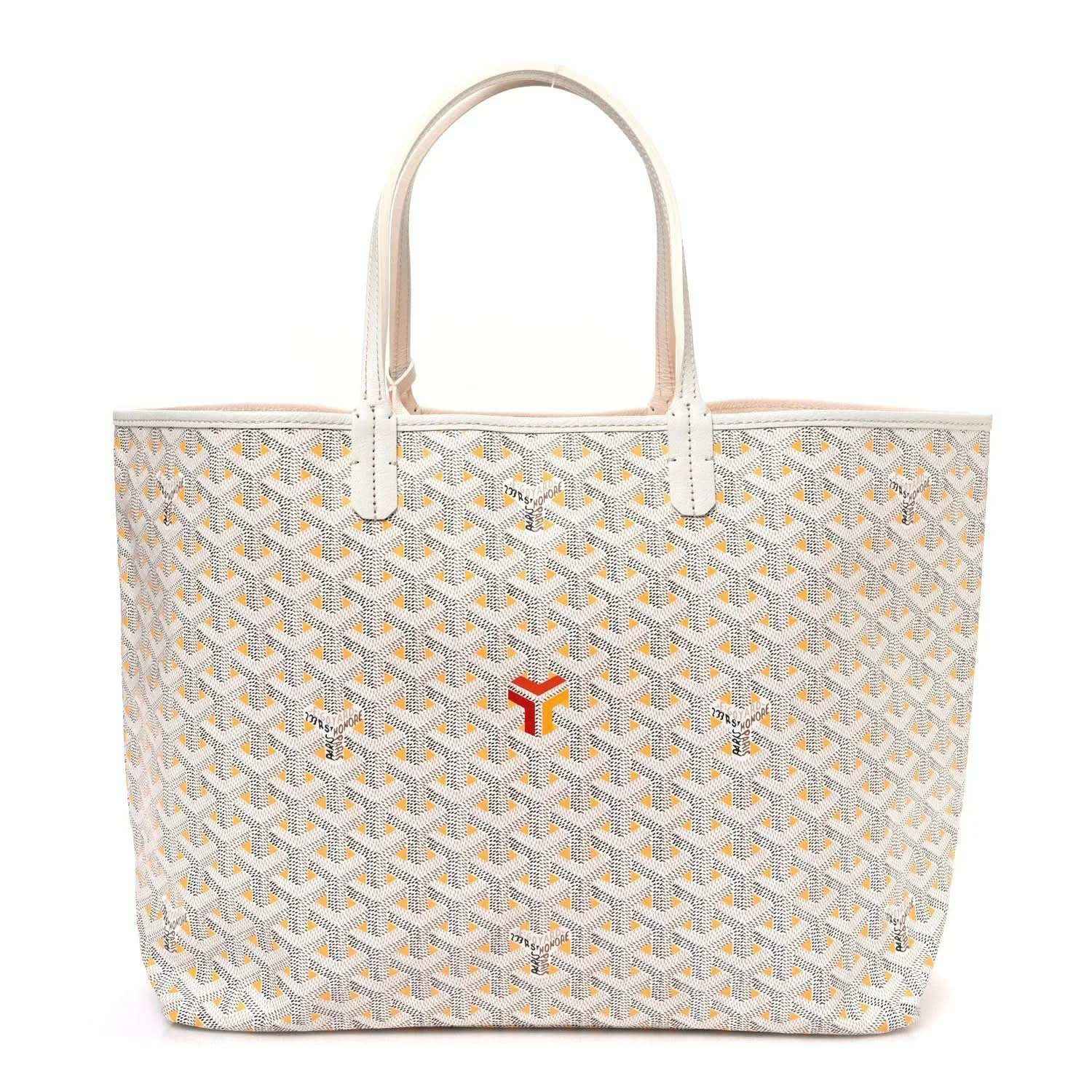 White tote bag with yellow Goyardine pattern, leather handles, and red logo accent at front
