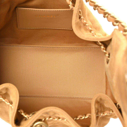 Chanel suede handbag interior with stitched edge and chain hardware close-up