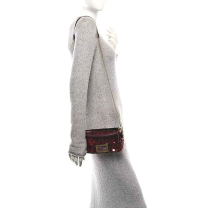 Mini baguette handbag worn crossbody, red sequin body with chain strap and gold clasp