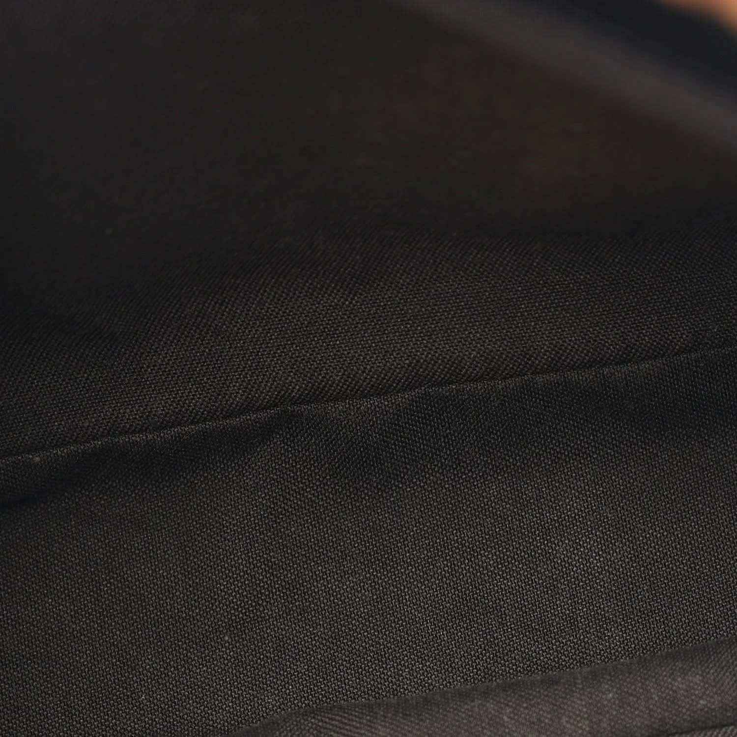 Black and brown fabric panel with textured seam detail on the Baguette bag.