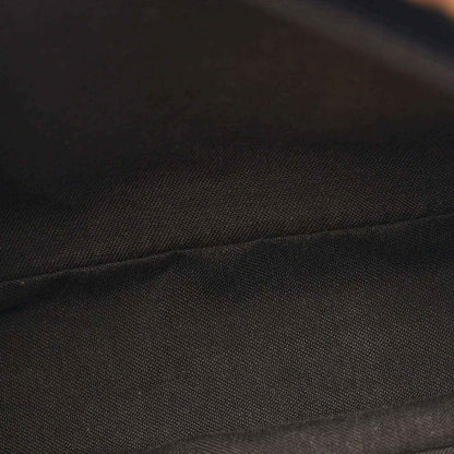 Black and brown fabric panel with textured seam detail on the Baguette bag.