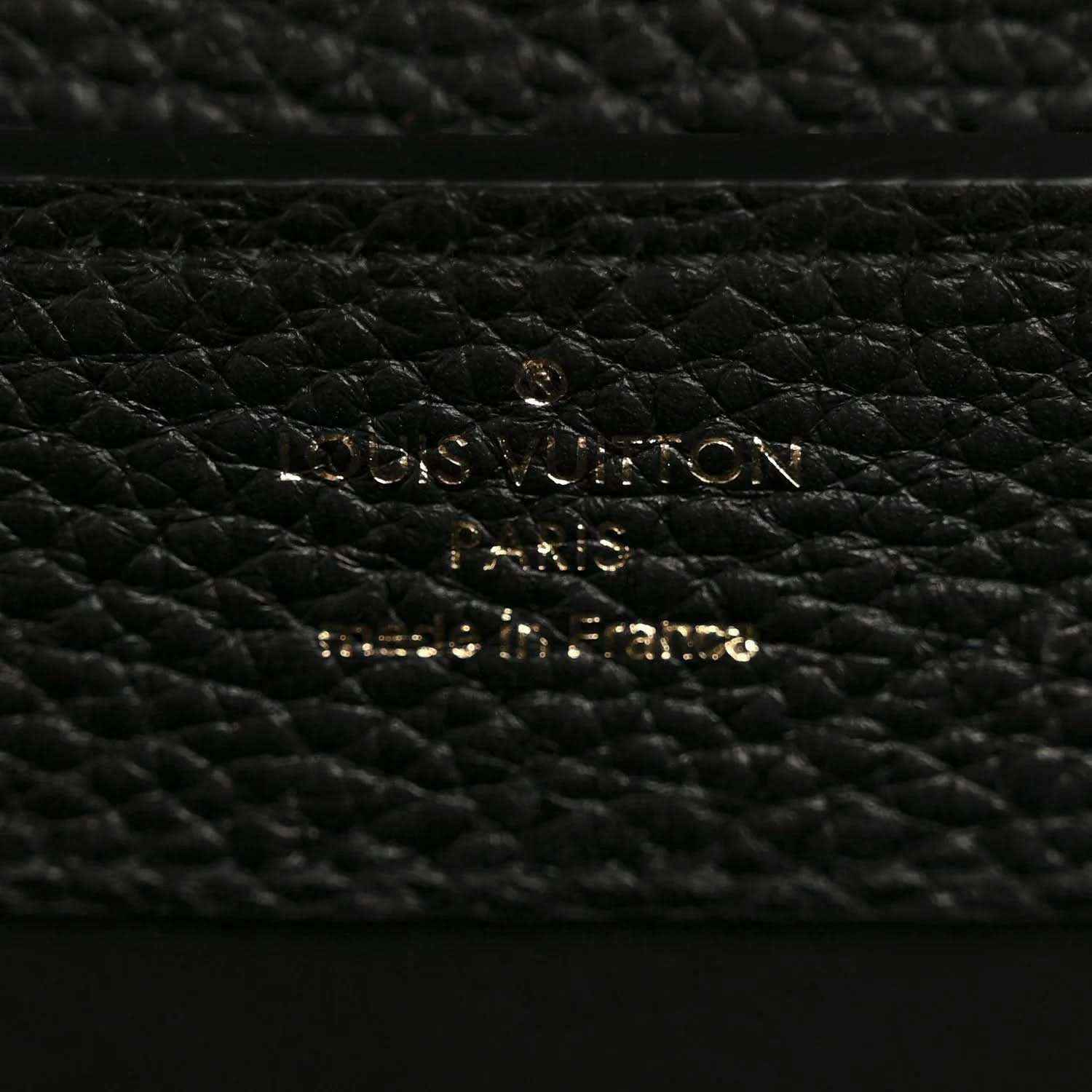 Black pebbled leather mini handbag close-up of gold hardware on lining