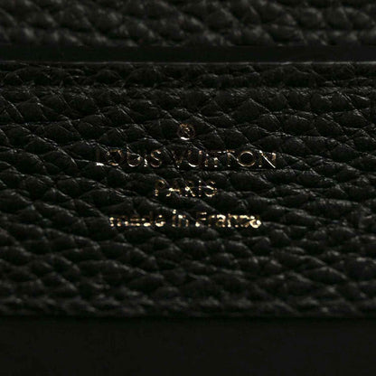 Black pebbled leather mini handbag close-up of gold hardware on lining