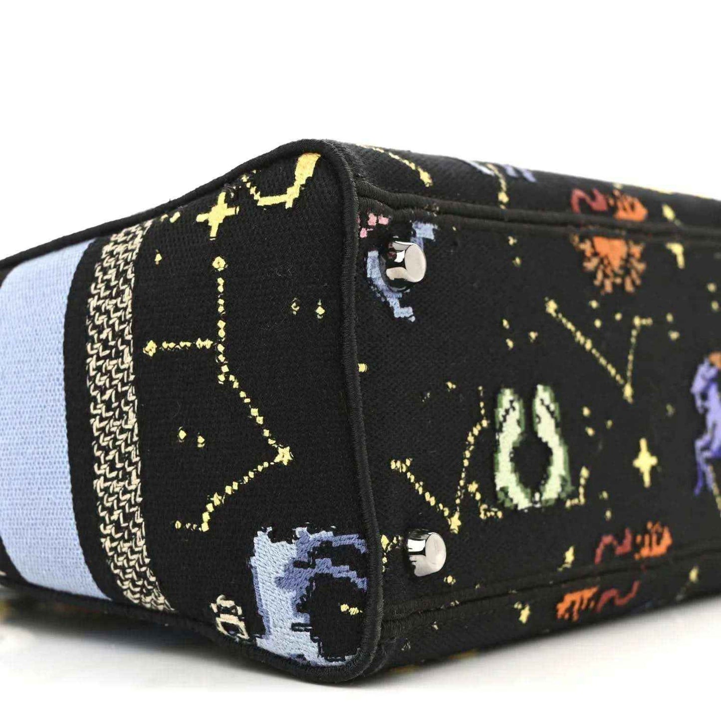 Black canvas handbag end panel with embroidered zodiac figures and two metal snap buttons