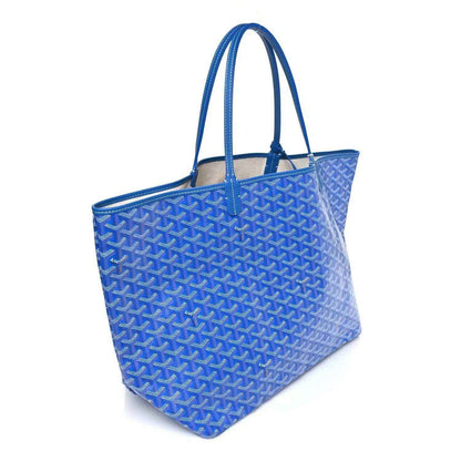 Sky blue Goyardine GM tote bag with two top handles and woven Goyard pattern.