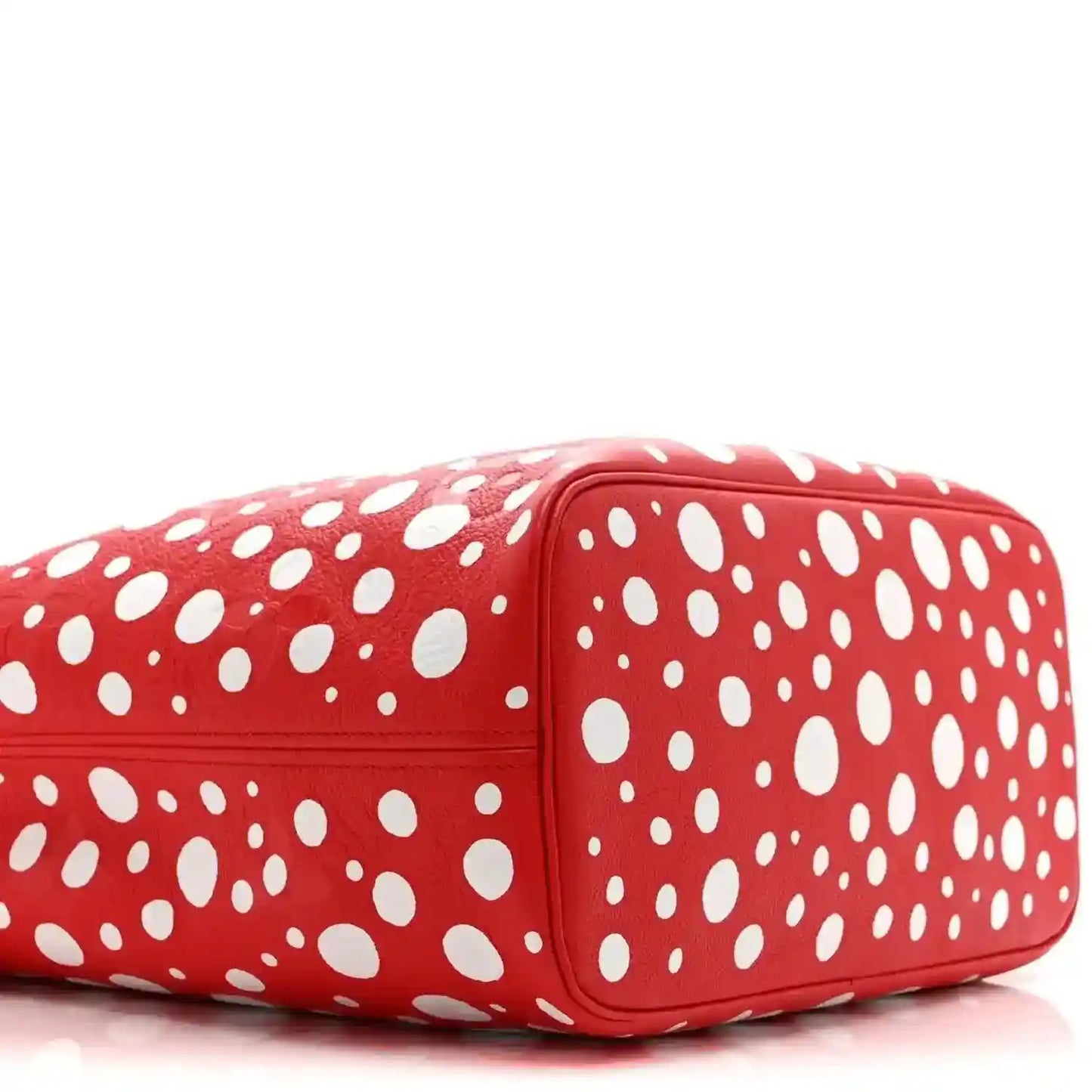 Red polka-dot tote bag end view with rounded corners and white dot pattern