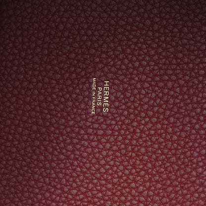 Burgundy grained leather panel with embossed brand text
