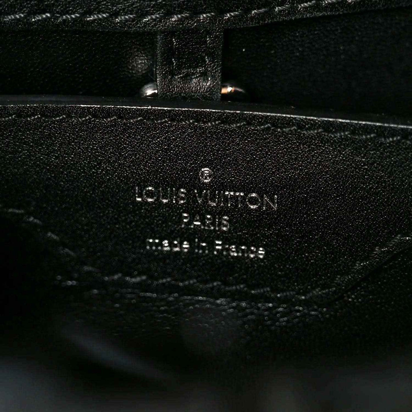 Louis Vuitton Paris made in France stamp on black leather lining with stitching