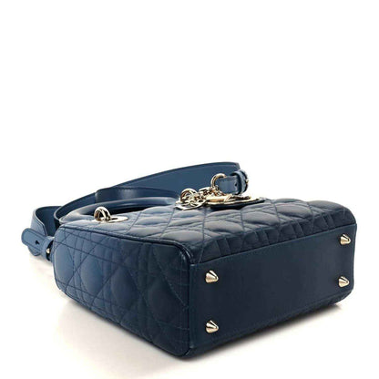 Small quilted indigo blue leather handbag with gold-tone corner studs and top clasp