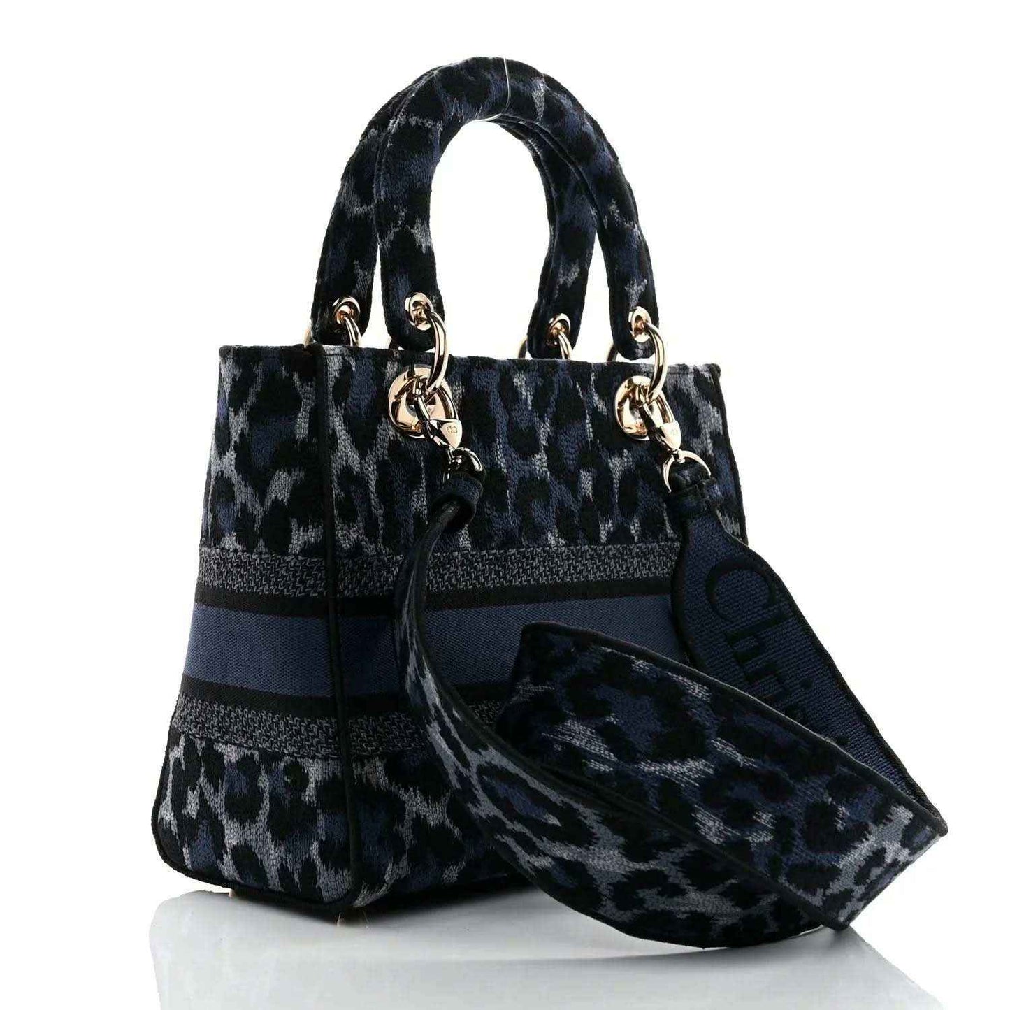 Christian Dior handbag with leopard-print canvas, navy trim, and logo charm