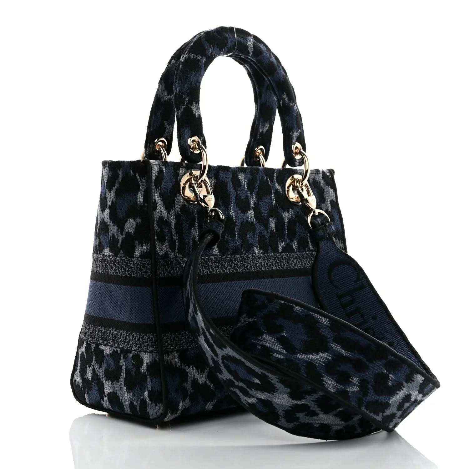Christian Dior handbag with leopard-print canvas, navy trim, and logo charm