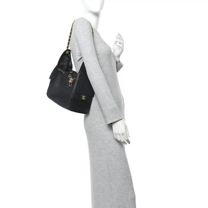 Chanel small handbag, black perforated calfskin, chain strap and side view