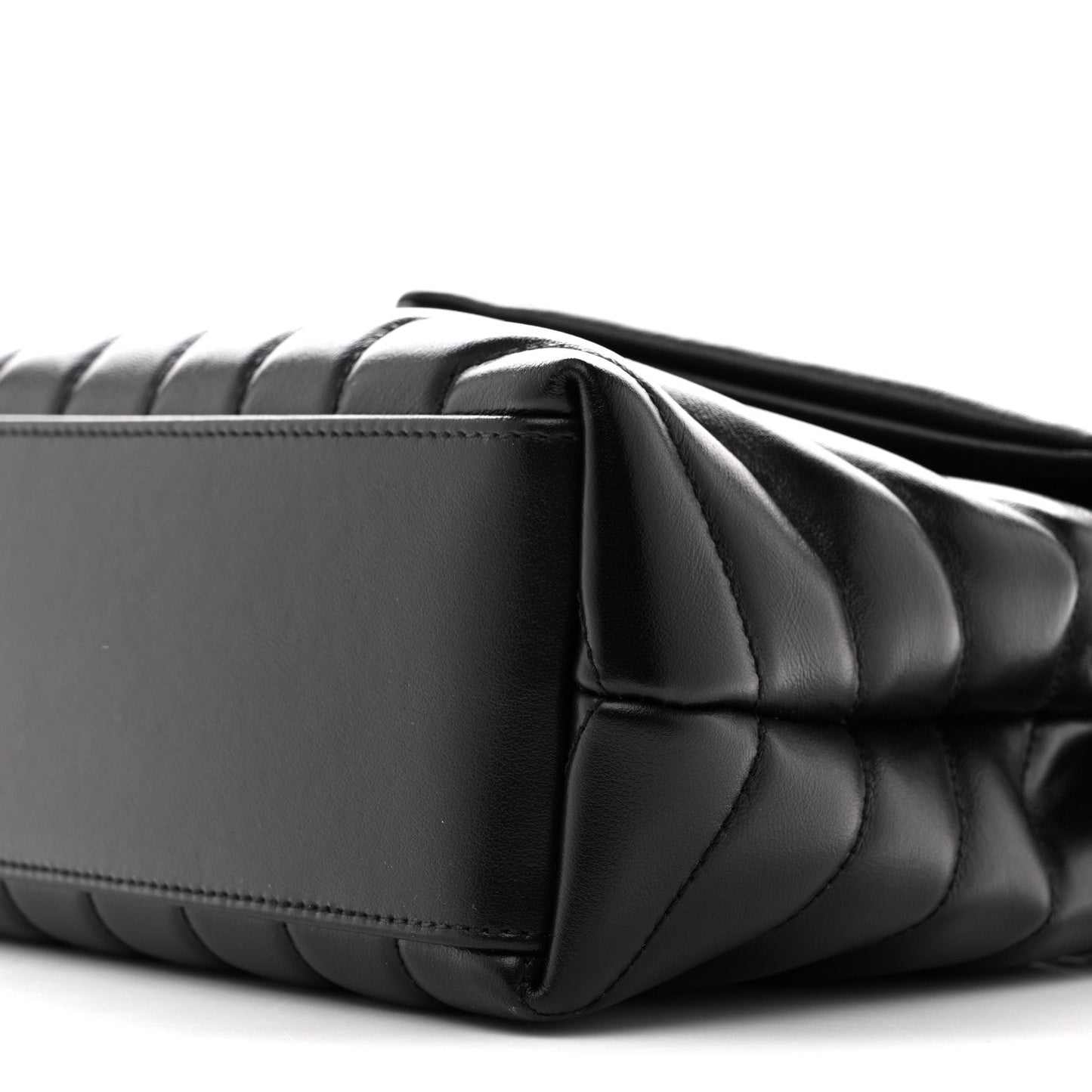 Black quilted satchel corner with chain strap and top edge seam